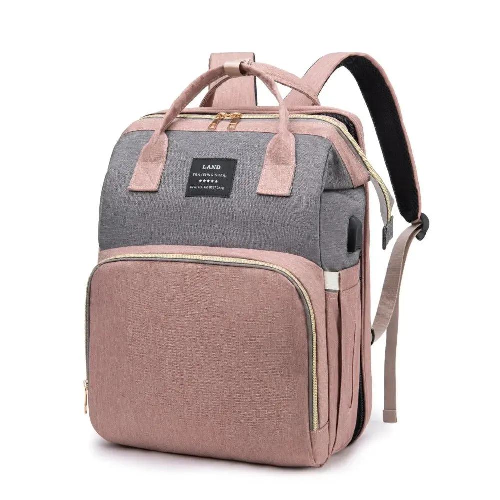 Two-tone backpack with gray top section and pink bottom section on a white background