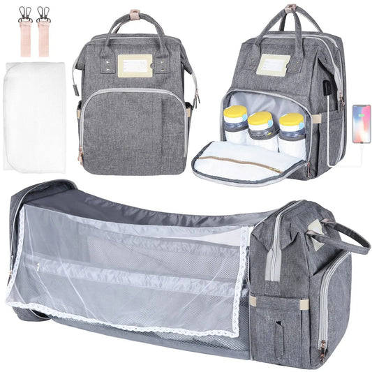 Gray diaper bag with multiple compartments and accessories on a white background